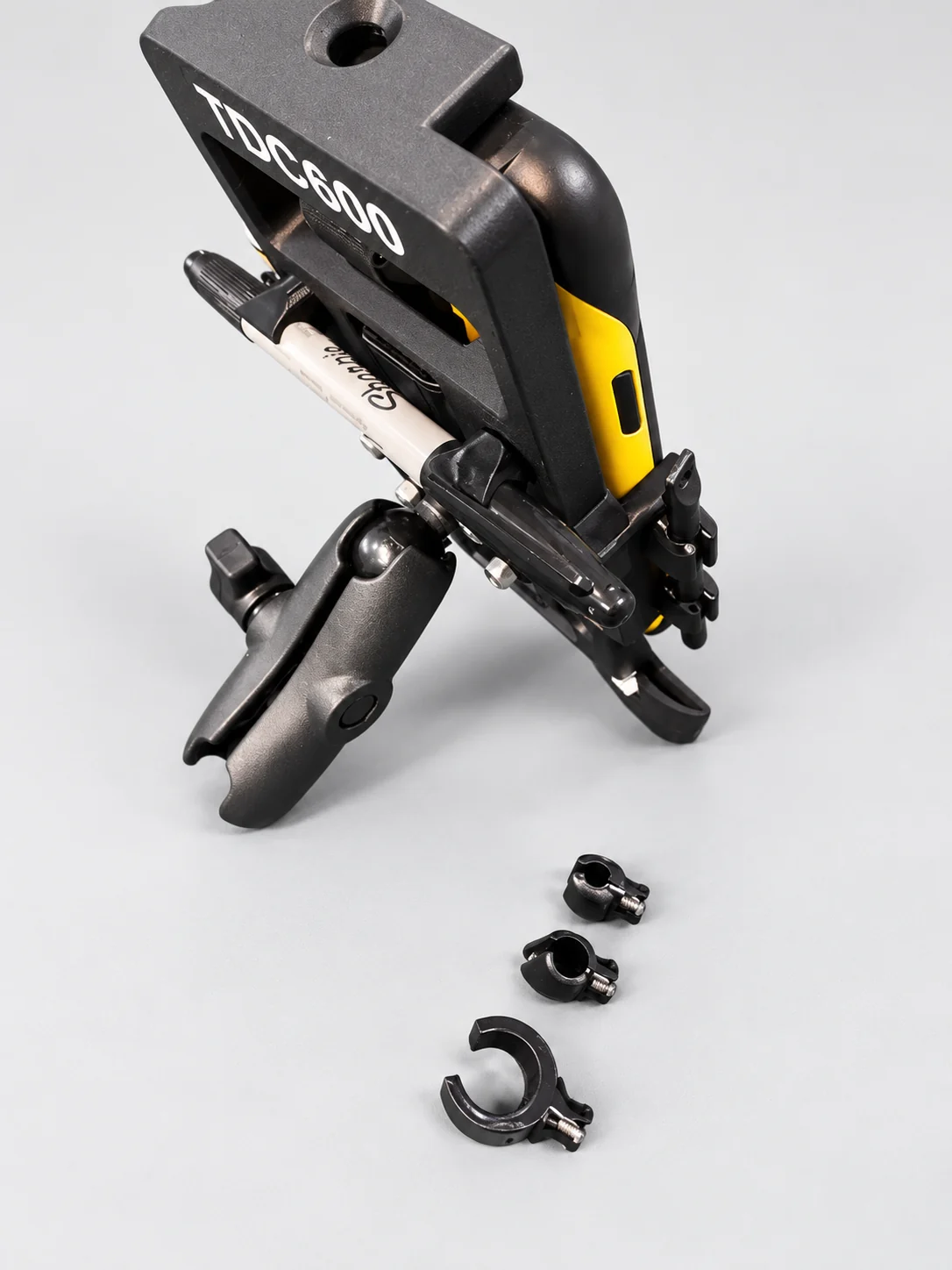 Side view of the Trimble TDC600 holder attached to a RAM-style mount with three configurable holder inserts